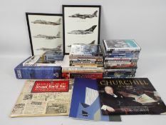 A collection of military related DVDs, books and similar.