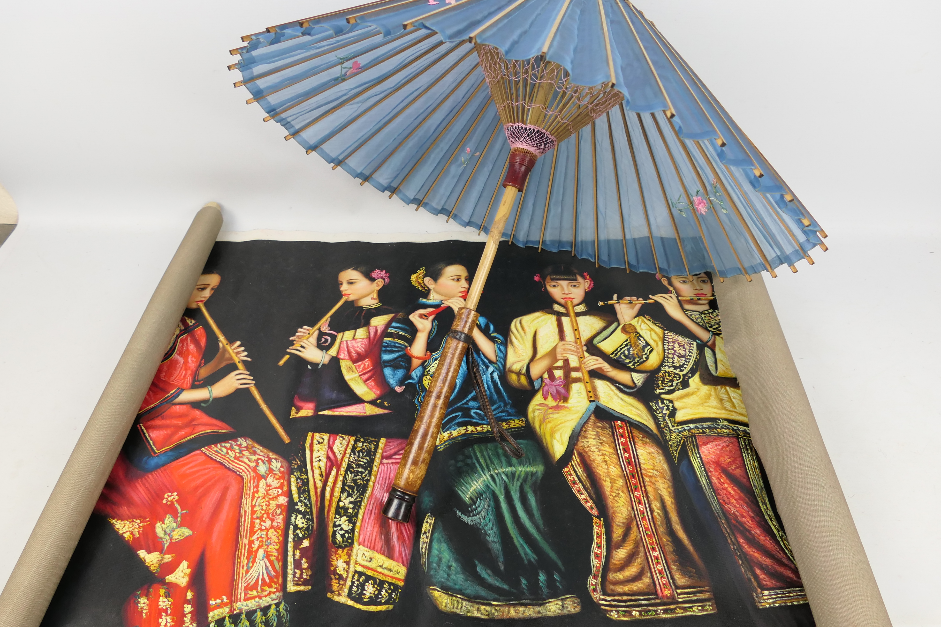 An Oriental silk parasol and an Oriental painting depicting musicians.