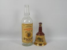 A Wade Bells whisky decanter with contents, 75cl and 40% ABV and an empty 3 litre whisky bottle.
