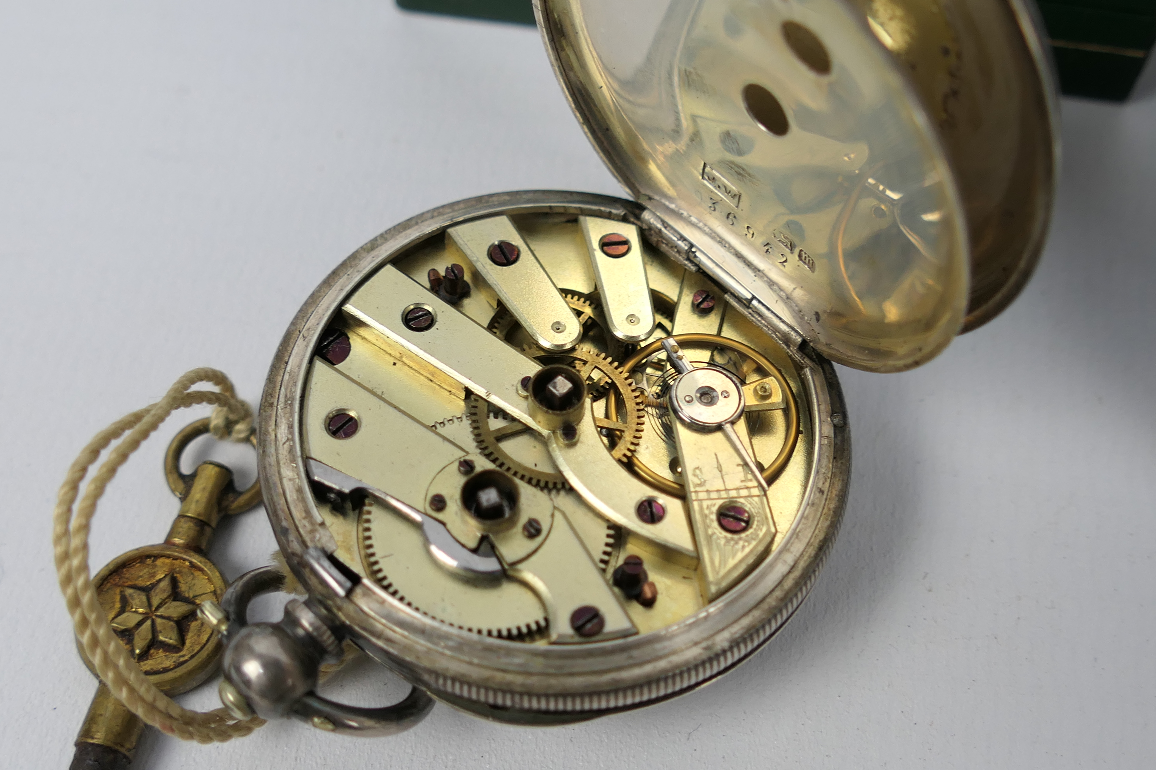 A silver cased, open face lady's pocket watch with Roman numerals to a white, - Image 4 of 6