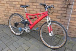 A vintage full suspension Coyote F2 mountain bike, 26" wheels with Shimano gears.