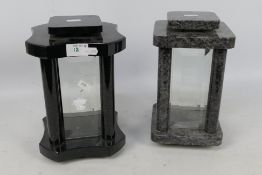Two hardstone framed candle lanterns, each with four bevelled glass panes, approximately 25 cm (h).