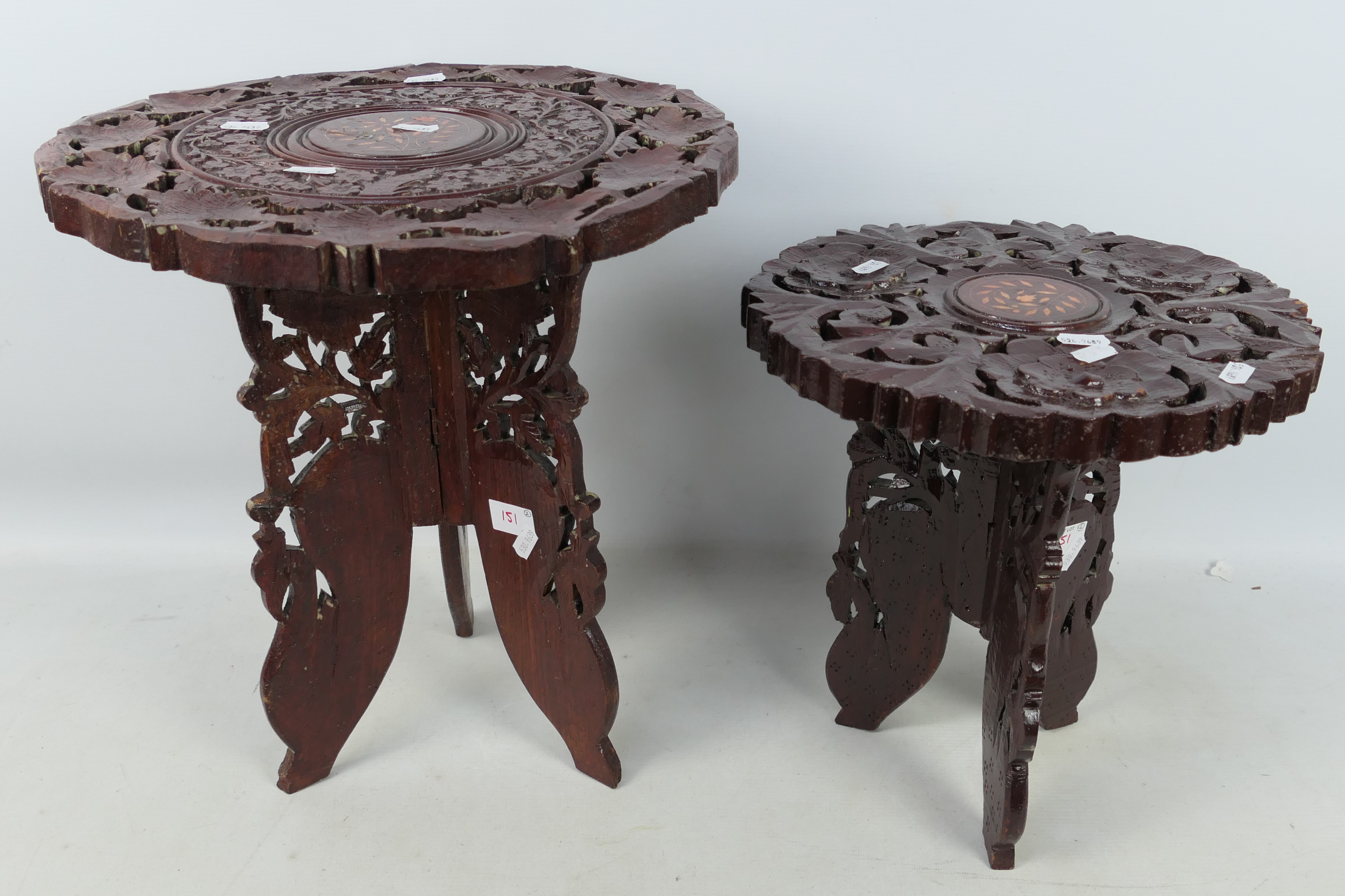 Two carved wood folding occasional tables, largest approximately 40 cm x 37 cm.