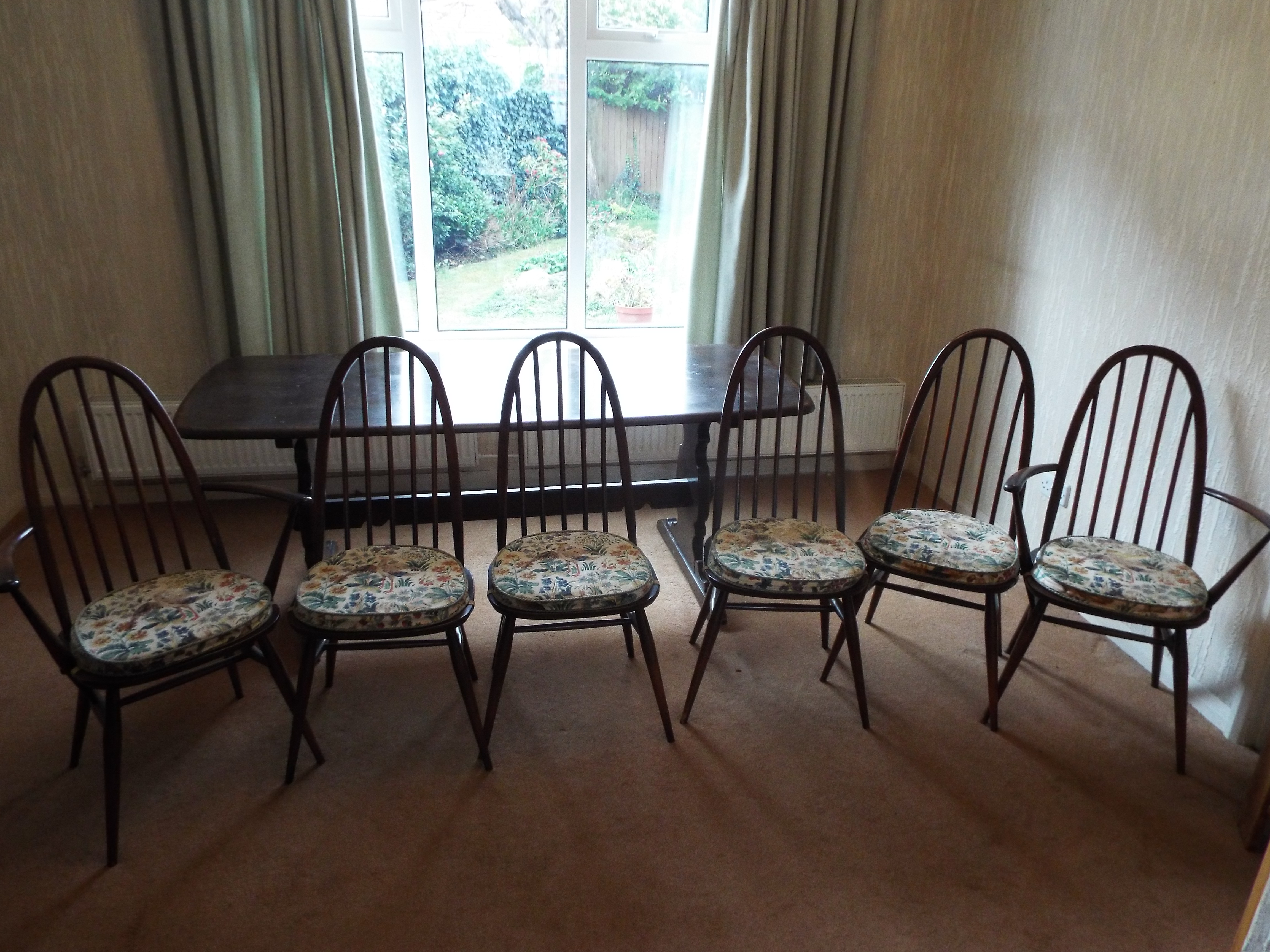 An Ercol refectory style dining table measuring approximately 72 cm x 182 cm x 81 cm with six