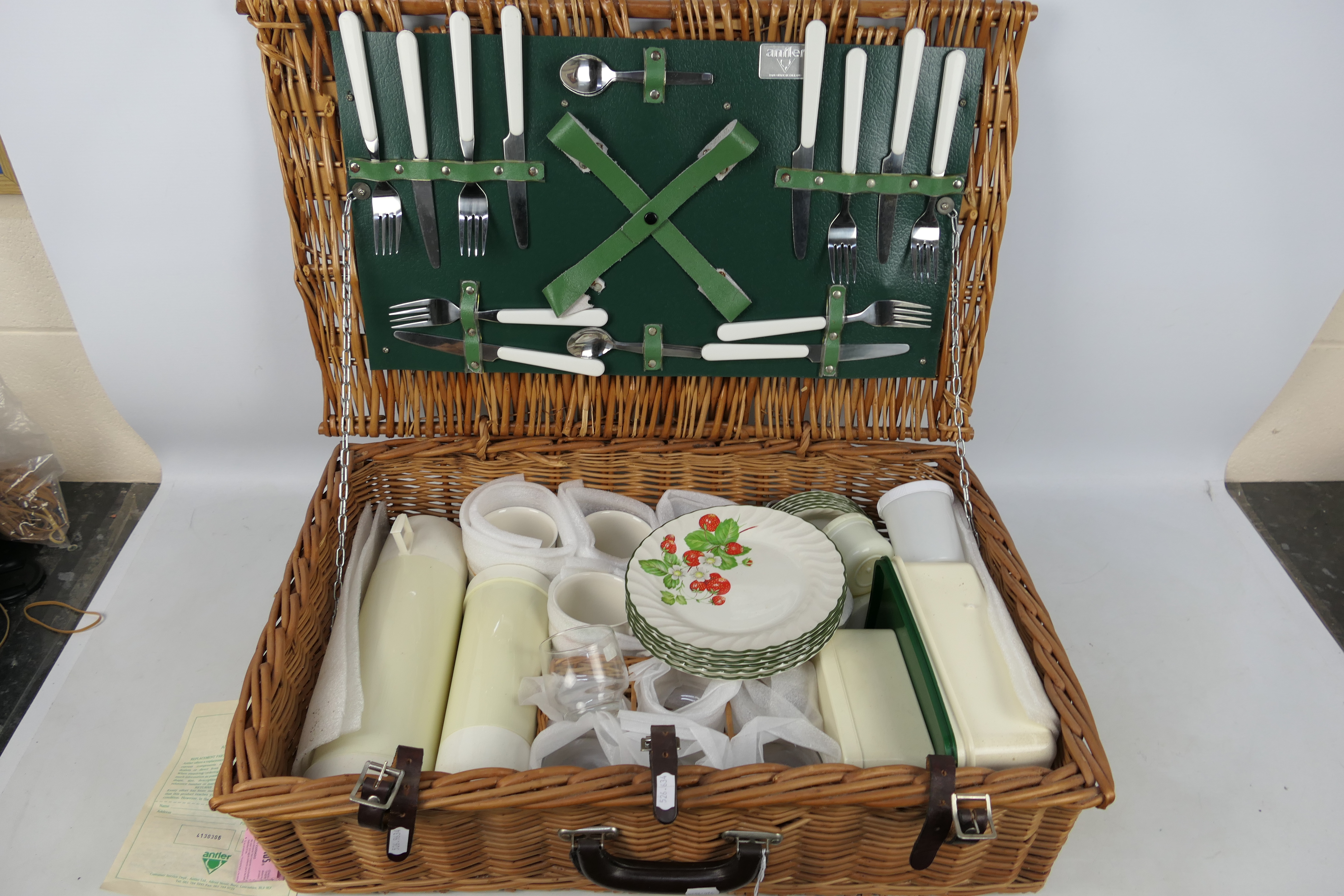 A vintage Antler picnic set in wicker basket.