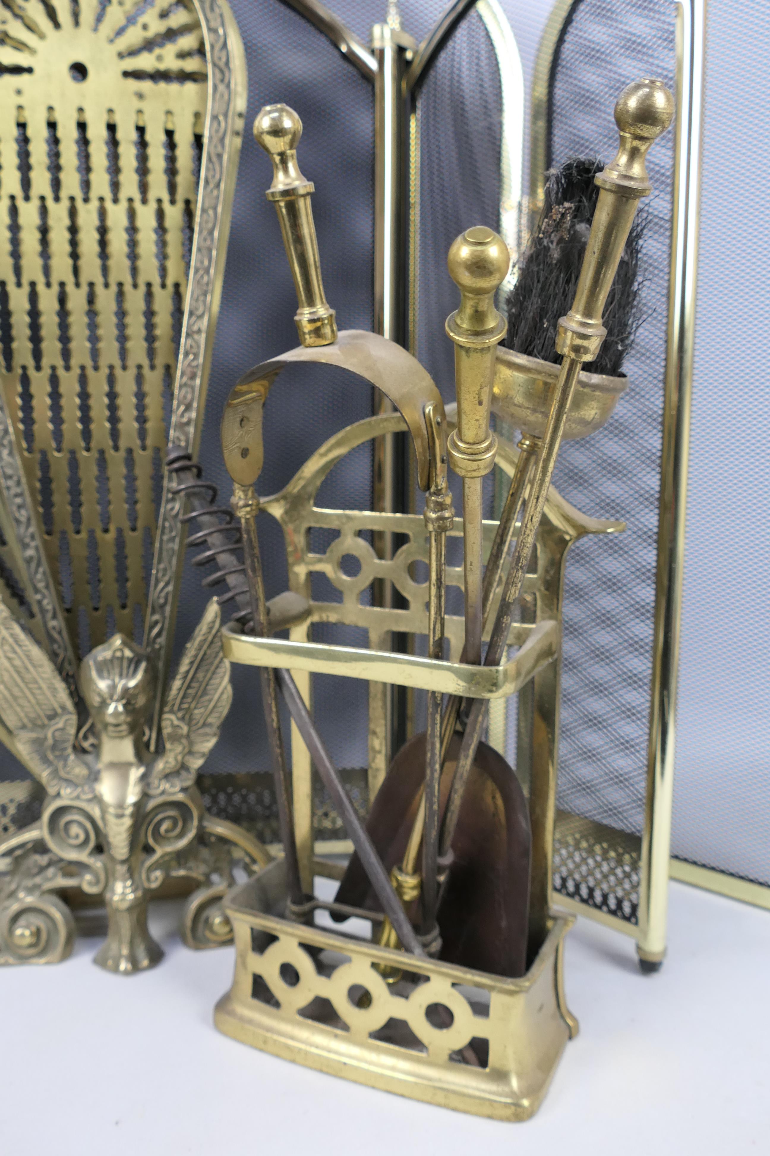 Three fire guards including a brass Peacock example and a brass fireside companion set. - Image 3 of 5