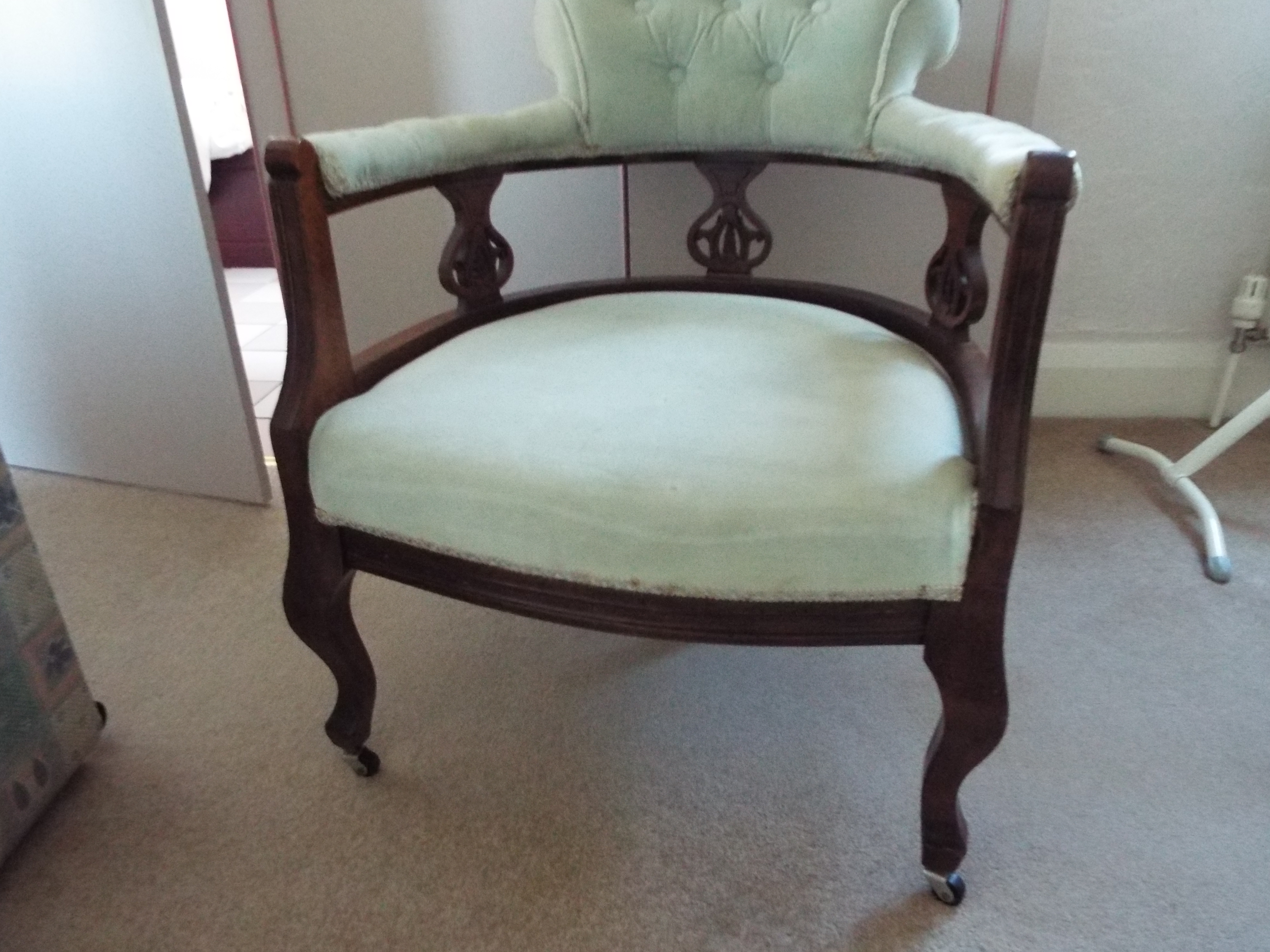 A mahogany framed armchair with upholstered back and seat.