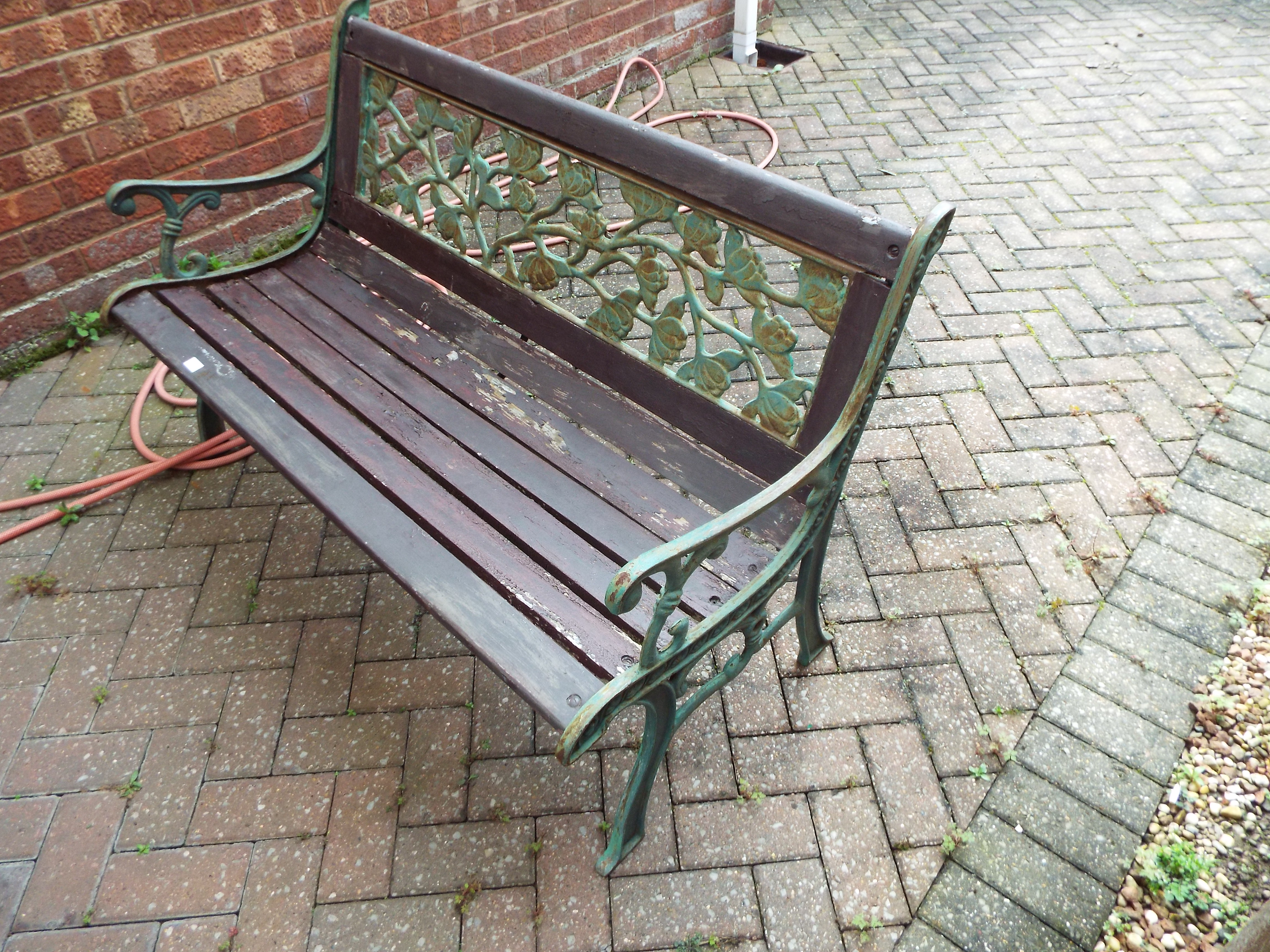 A cast metal and wood garden bench measuring approximately 75 cm x 127 cm 67 cm. - Image 2 of 5