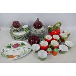 Dinner wares decorated with leaves and berries, kitchen storage jars and other.