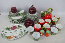 Dinner wares decorated with leaves and berries, kitchen storage jars and other.