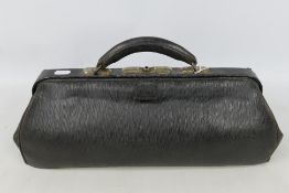 An antique leather doctors bag.