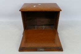 A vintage. fall front stationary box, approximately 26 cm x 35 cm x 22 cm.