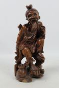 A carved wood figure depicting an elderly gentleman, approximately 24 cm (h).