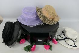A hat box containing a quantity of lady's hats.