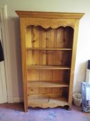 A pine freestanding bookcase comprising four shelves, approximately 180 cm x 100 cm x 34 cm.