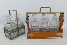 A three decanter tantalus with decanters and a twin division white metal decanter holder with two