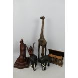 Carved wood elephants, giraffe group, coffer form cigarette box and similar.