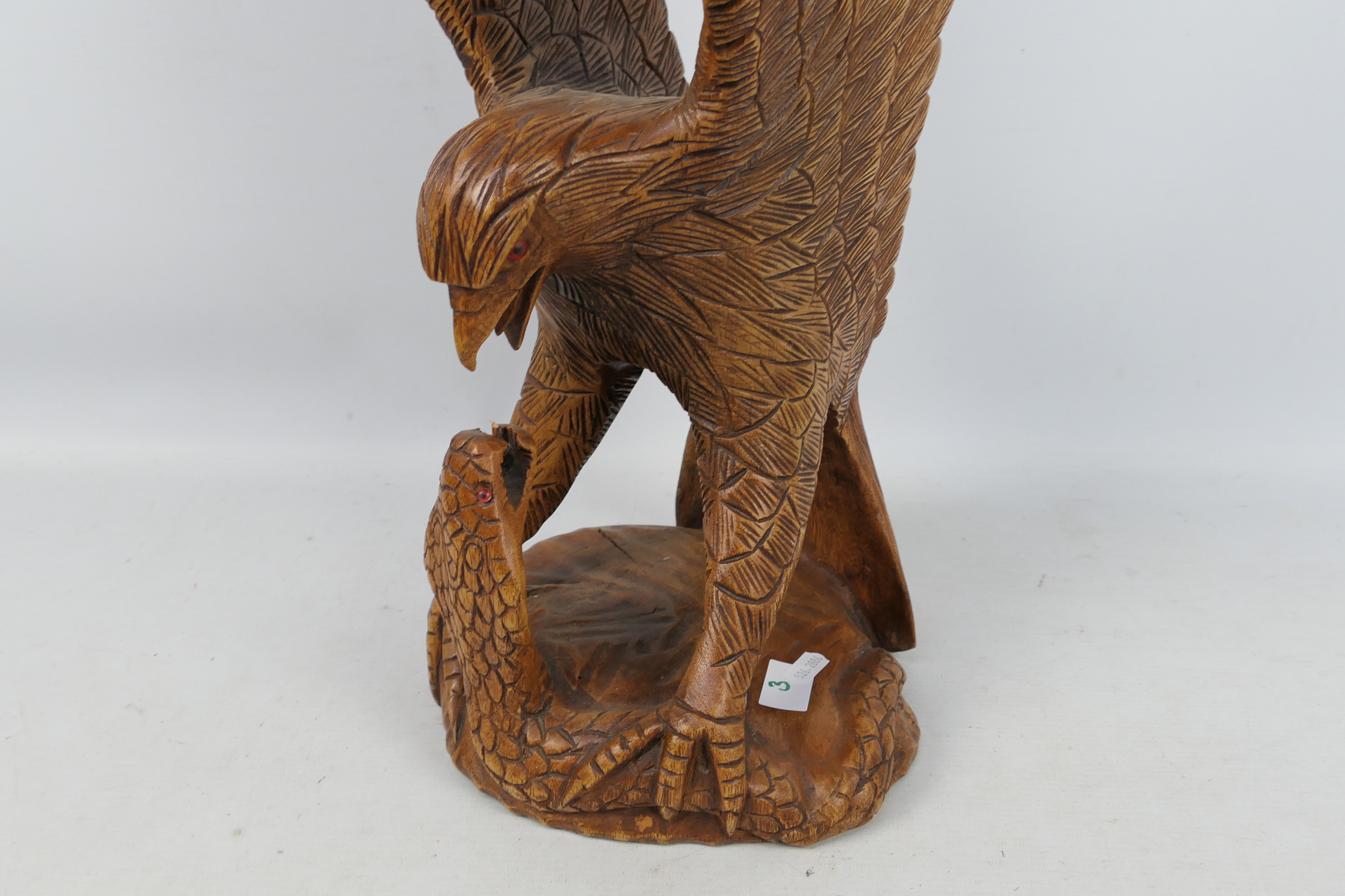 A large carved wood sculpture depicting an eagle attacking a cobra, - Image 2 of 4