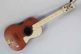 A Selcol Elvis Presley toy guitar,