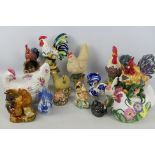 A collection of decorative figures of chickens and cockerels, varying sizes.