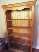 A pine freestanding bookcase comprising five shelves, approximately 190 cm x 100 cm x 30 cm.