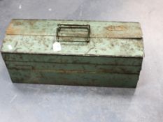 A vintage tool box containing a quantity of hand tools.