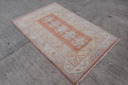 A carpet with geometric floral decoration, approximately 296 cm x 197 cm.