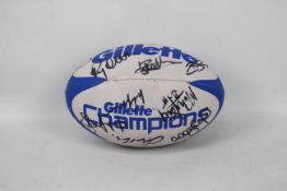 A rugby ball bearing signatures of the Warrington Wolves team (signatures unverified).