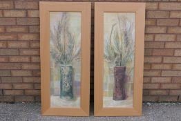 A set of two beech framed prints, each a floral still life, approximately 90 cm x 29 cm image size.