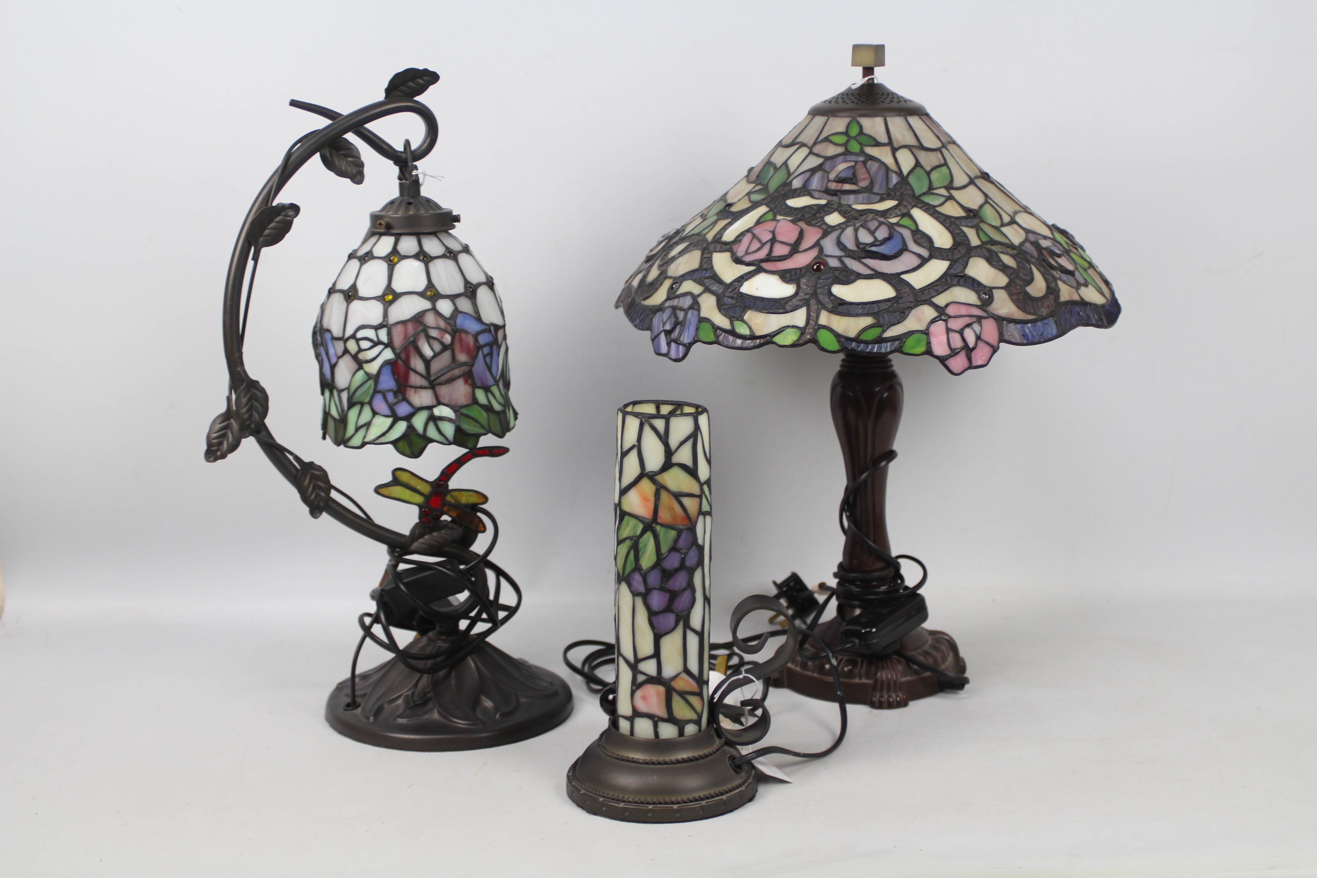 Three Tiffany style table lamps, largest approximately 49 cm (h).