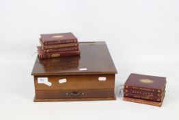 A vintage writing box with hinged lid and lower drawer containing a quantity of publications