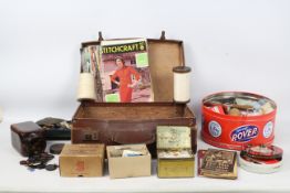 A vintage case and a quantity of haberdashery related items to include thread,