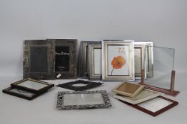 A collection of photograph frames, various sizes.
