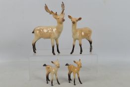 Beswick - A four piece Fallow Deer family comprising stag, doe and two fauns,