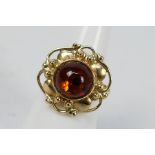 A mid-purity yellow metal and amber ring, Polish marks for 14ct, size N, approximately 6.3 grams.