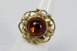 A mid-purity yellow metal and amber ring, Polish marks for 14ct, size N, approximately 6.3 grams.