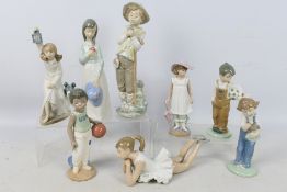 Eight Nao figures depicting children, largest approximately 27 cm (h).