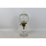 A heavy glass oil lamp with star cut base and clear glass shade, approximately 50 cm (h).