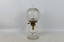A heavy glass oil lamp with star cut base and clear glass shade, approximately 50 cm (h).