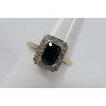 A 9ct yellow gold sapphire and diamond set cluster ring, size N+½, approximately 3 grams all in.