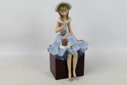 Lladro - A figural group entitled Suzy And Her Doll # 1378, approximately 28 cm (h).
