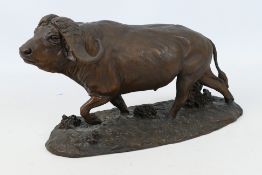 A cold-cast bronze buffalo statue by Robert Glen.