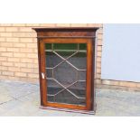 A mahogany display cabinet with single astragal glazed door, approximately 80 cm x 60 cm x 24 cm,