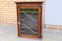 A mahogany display cabinet with single astragal glazed door, approximately 80 cm x 60 cm x 24 cm,