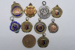 A collection of sporting medals to include a silver and enamel example Portsmouth Football