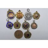 A collection of sporting medals to include a silver and enamel example Portsmouth Football