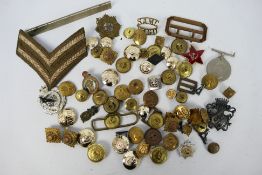A collection of military buttons, badges, insignia and similar.