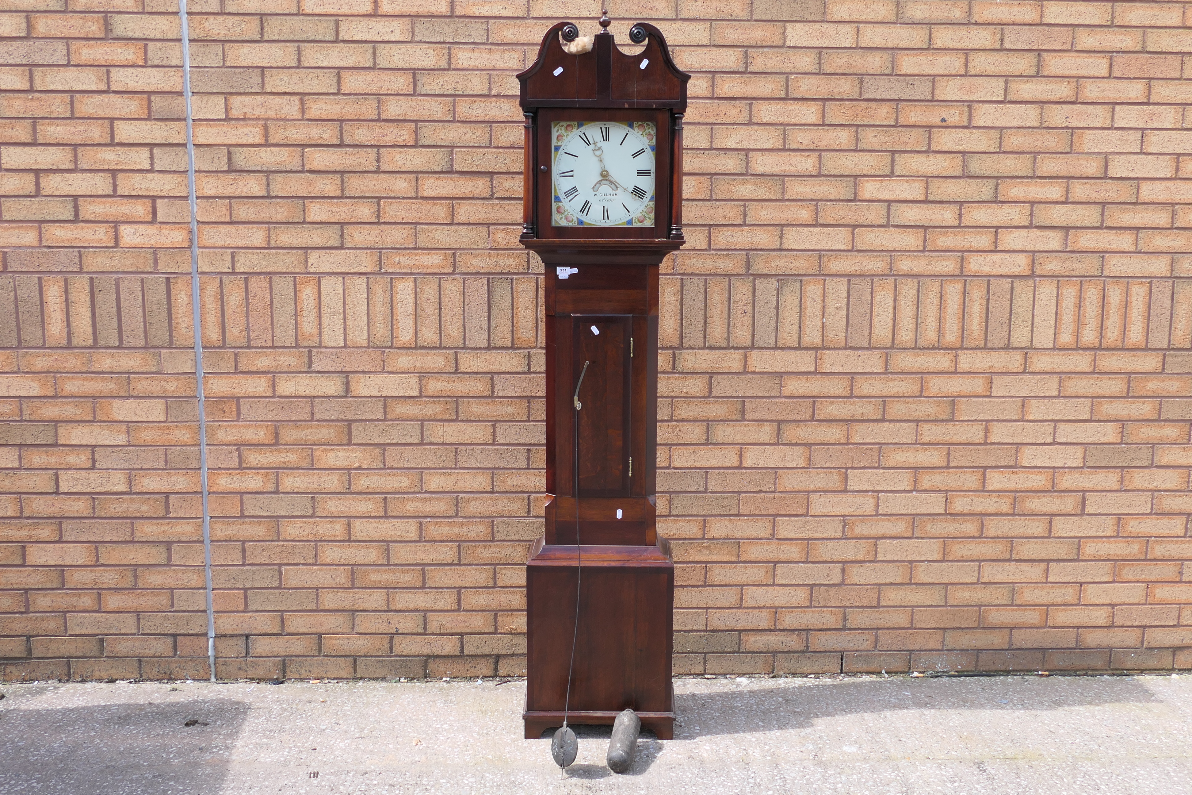 A mid-19th century oak cased 30-hour longcase clock, the hood surmounted by swan-necked pediment,
