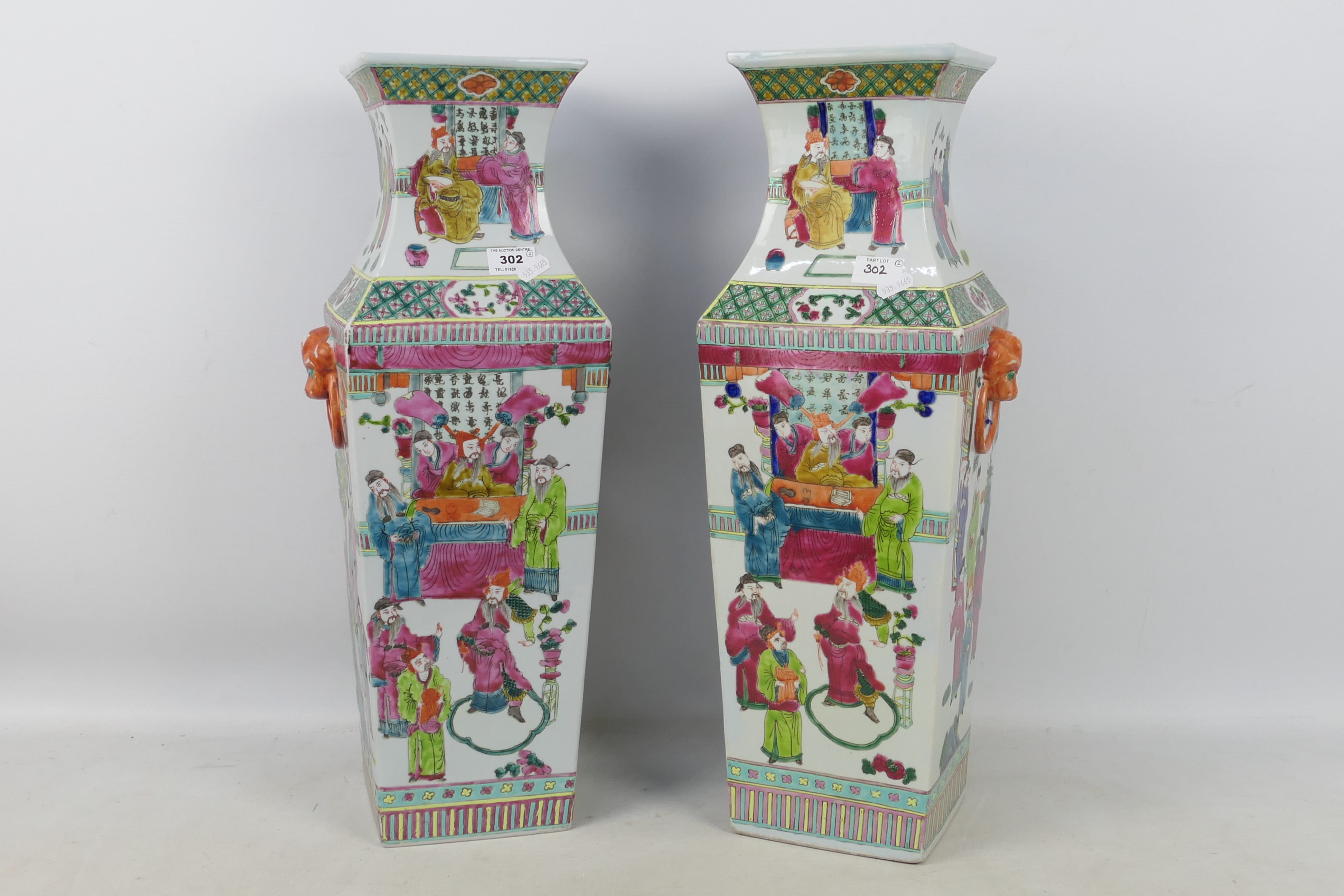 A large pair of famille rose square section vases decorated with panels of figures in court scenes