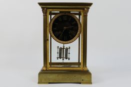 A French crystal regulator 4-glass brass and glass mantel clock with four bevelled glass panes,